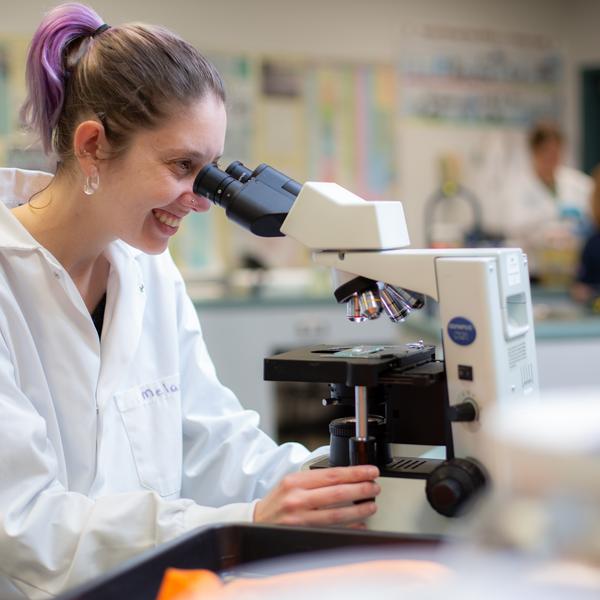 Fish and Aqua student at the microscope
