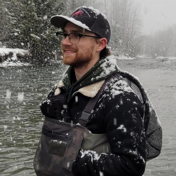 Student standing next to a stream