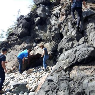 Students examining deformed rocks on Quadra Island for GEOL206 field school