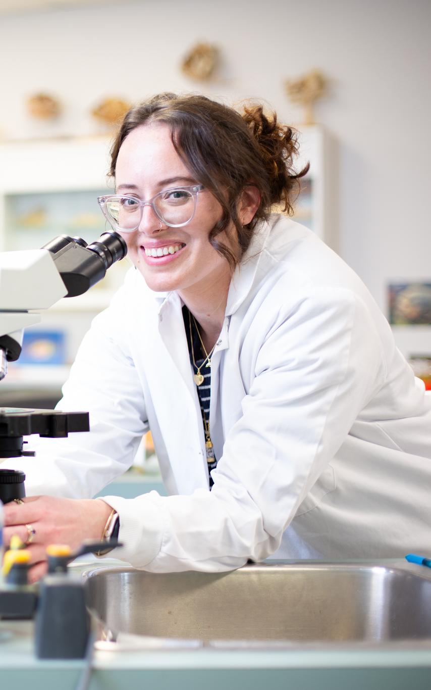 VIU student smiling at the microscrope