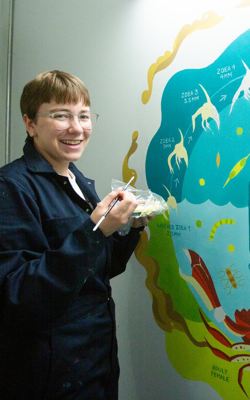 VIU student painting a mural